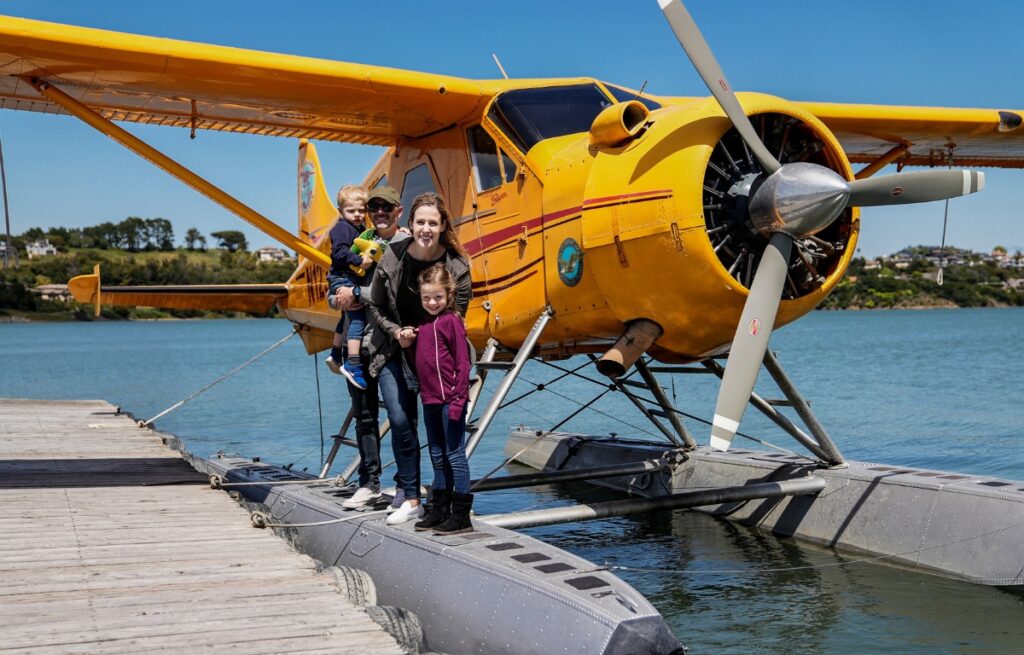 a family doing something unique in san francisco while standing on a seaplane in the water