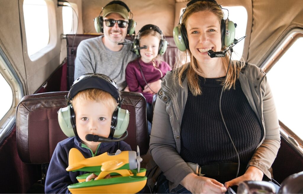 a family on a seaplane tour flying above the san francisco bay