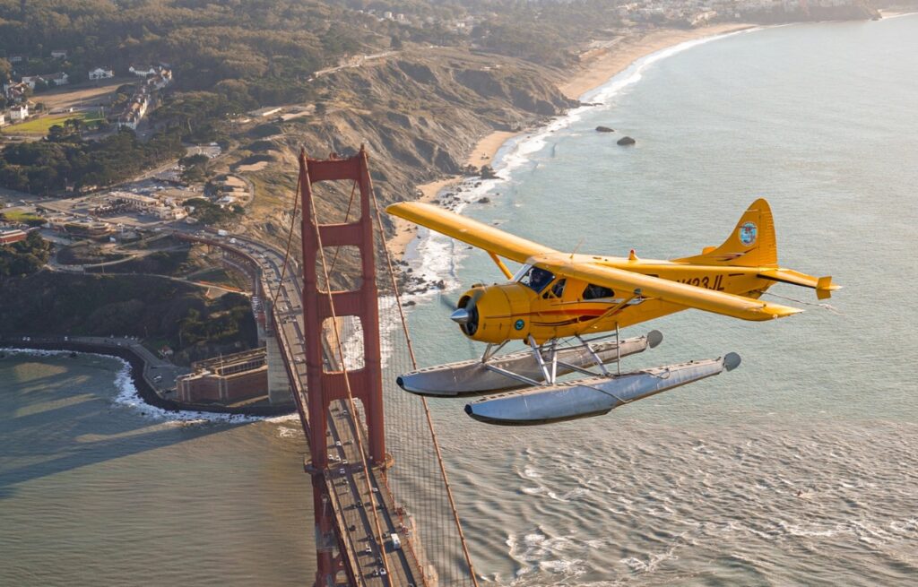 a seaplane flying above the golden gate bridge on a tour