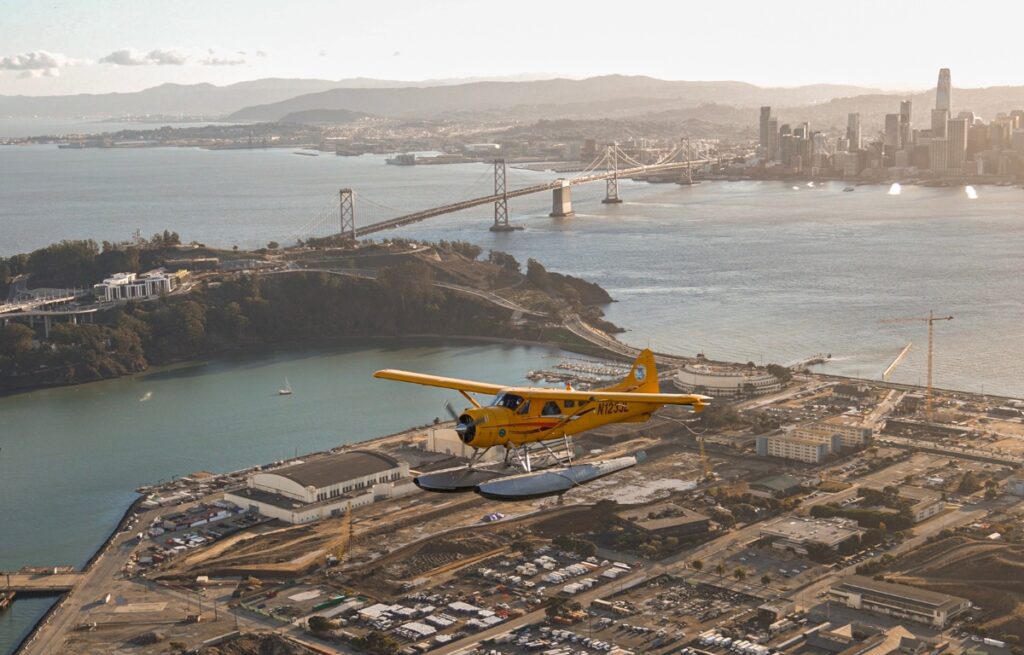 a yellow seaplane flying over Sausalito for something fun to do in san francisco